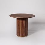 Skinner Four-Seater Dining Table in dark brown acacia wood with a sculptural base and brass detailing