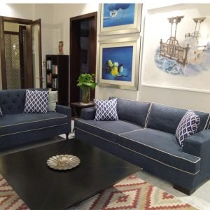 Sofa with elegant piping detail and plush, premium upholstery.