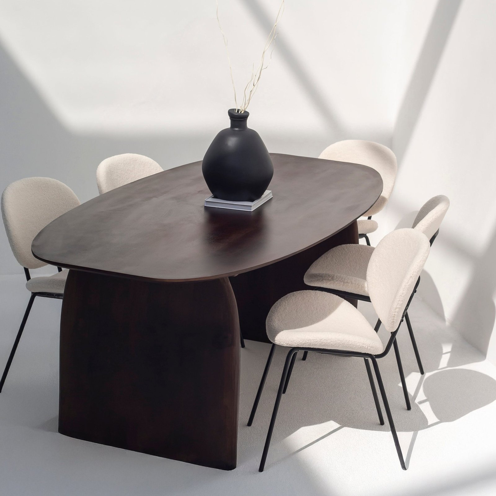 Galienne Oval Dining Table with a smooth solid wood surface and slender base, ideal for modern or transitional interiors