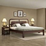 Solid wood bed with rattan cane headboard in a naturally styled bedroom