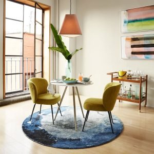 Koko Chair with soft curved silhouette and plush upholstery