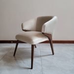 "Sage wooden designer chair with curved back and natural finish"