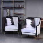 Monochrome velvet accent chair with gold brass legs and modern design