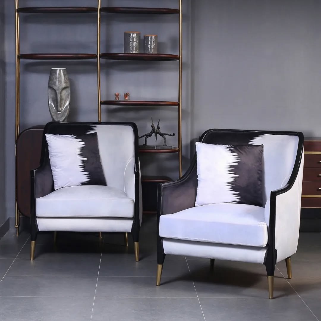 Monochrome velvet accent chair with gold brass legs and modern design