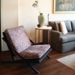 Vista Lounge Chair with pleated backrest and solid oak frame in a modern living room setting