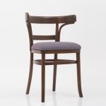 Vintage bistro chair with a curved wooden backrest and upholstered seat in a classic dining setting