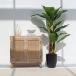 Lori Rattan Sideboard with two doors, a natural wood frame, and handwoven rattan panels, designed for stylish and functional storage.