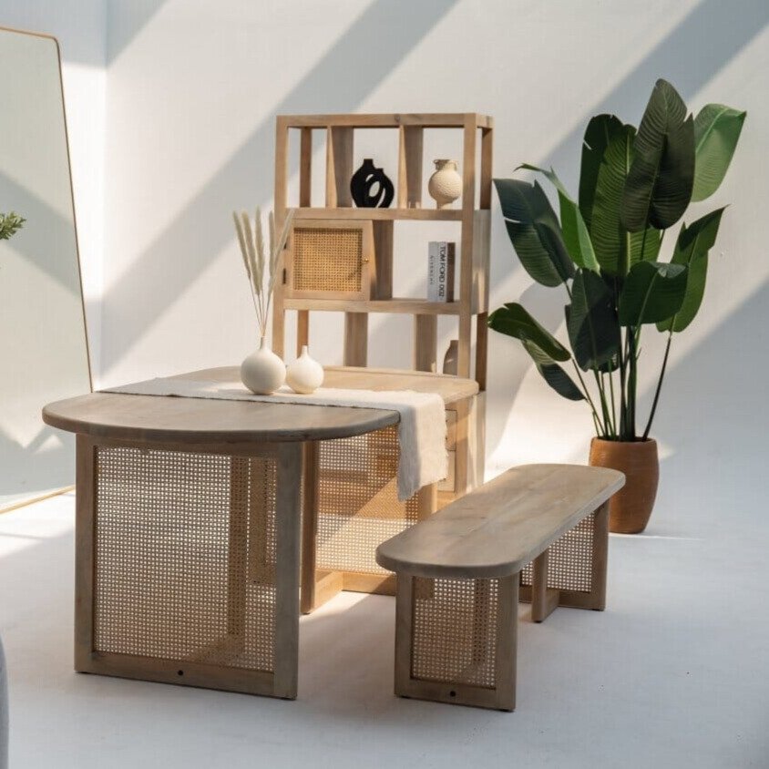 Ariana wooden dining table with natural finish and rattan-wrapped legs