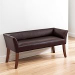 Upholstered bed bench with arms, wooden frame, and elegant padded seating.