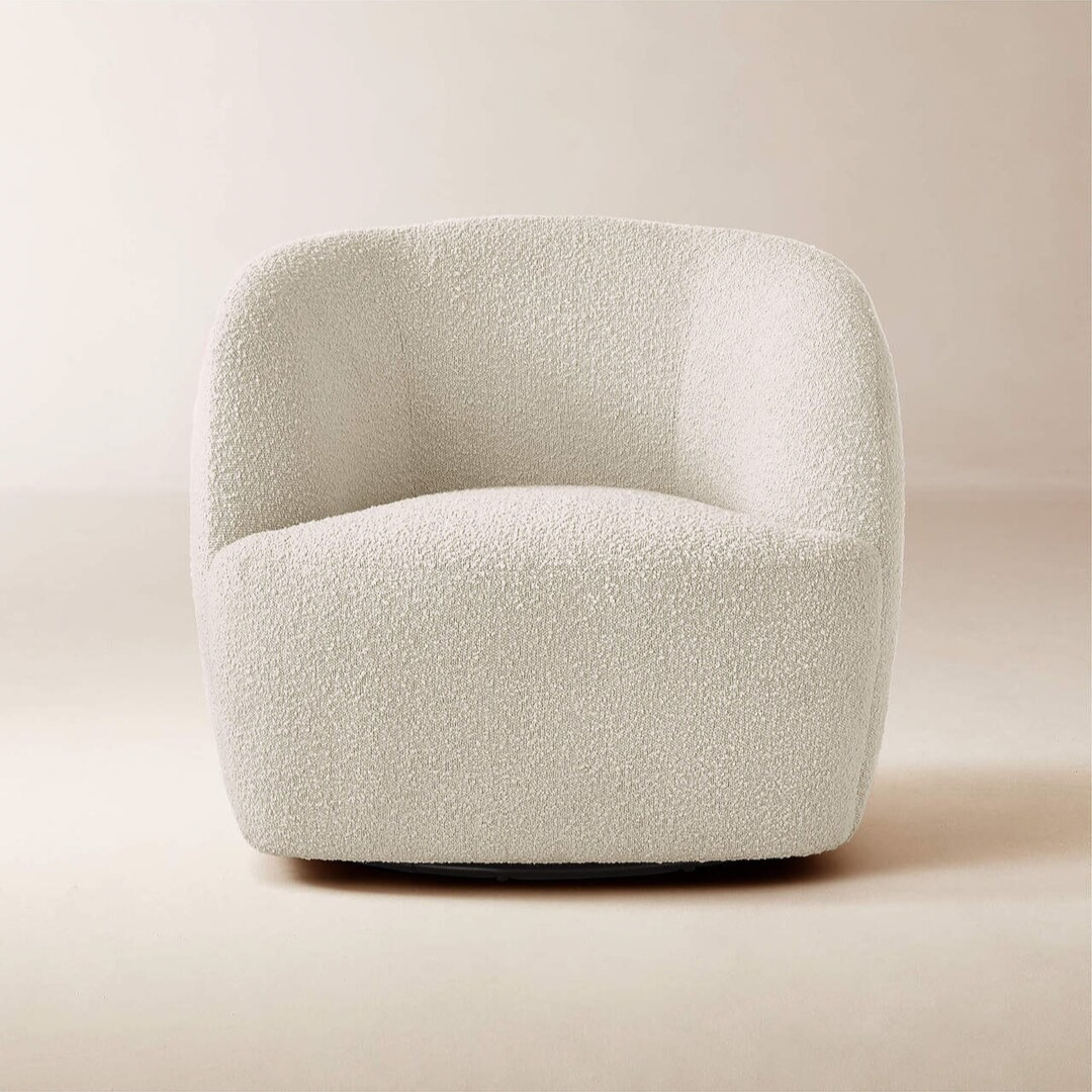 Grevy Swivel Chair – rounded modern swivel chair with soft fabric and sculptural silhouette