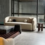 Nordic Sofa in neutral fabric with tapered wooden legs in a modern living room