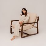 Unik wooden chair with sculpted back and angular legs in a minimalist interior