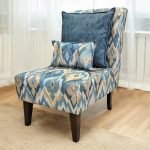 Slipper chair with geometric patterned upholstery and matching accent pillows