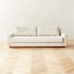 Claremont Ivory Sofa – elegant ivory upholstered sofa with curved arms and structured cushions