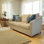 Kelsy Sofa in premium fabric with clean lines and wooden legs