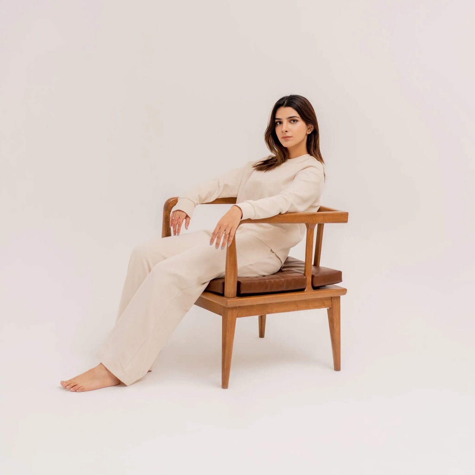 Cradle-style wooden lounge chair with curved frame and fabric upholstery