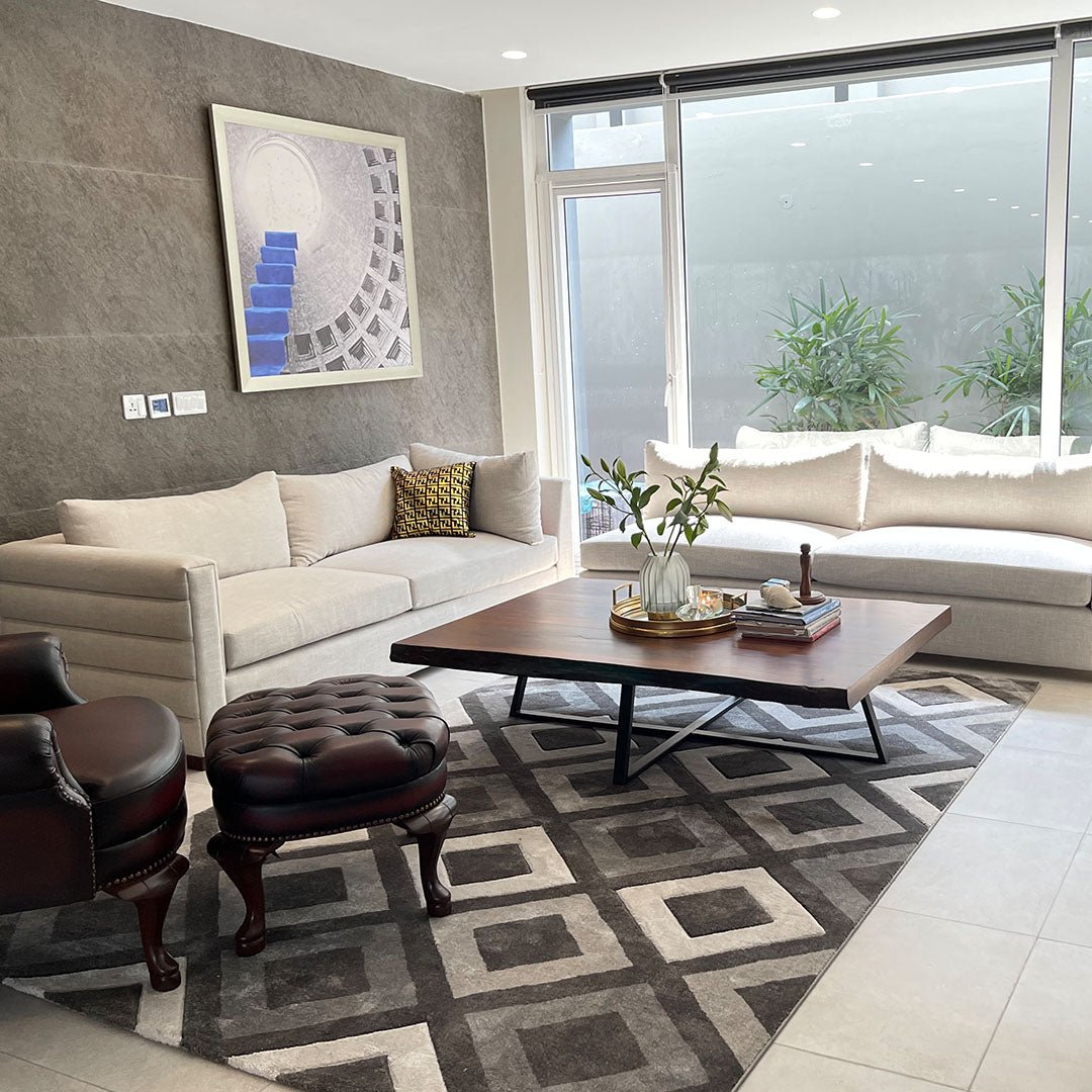 Classic-style sofa with rolled arms and fabric upholstery in an elegant living room setting