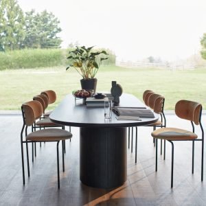 Moon Dining Table with circular top and sculptural base in a modern interior