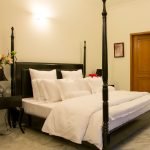 Midnight Majesty Bed with tall tufted headboard and deep velvet upholstery in a luxury bedroom