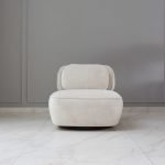 Roundel Chair with curved backrest and plush upholstery in a modern living space