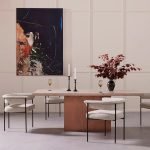 Zera Dining Chair with curved back and upholstered seat in a modern dining room setup