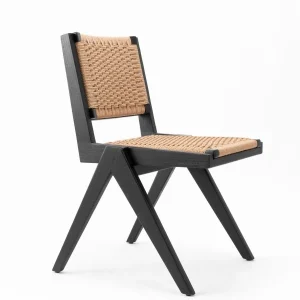 The Windsor Chair in natural wood finish with curved back and spindles in a bright dining room