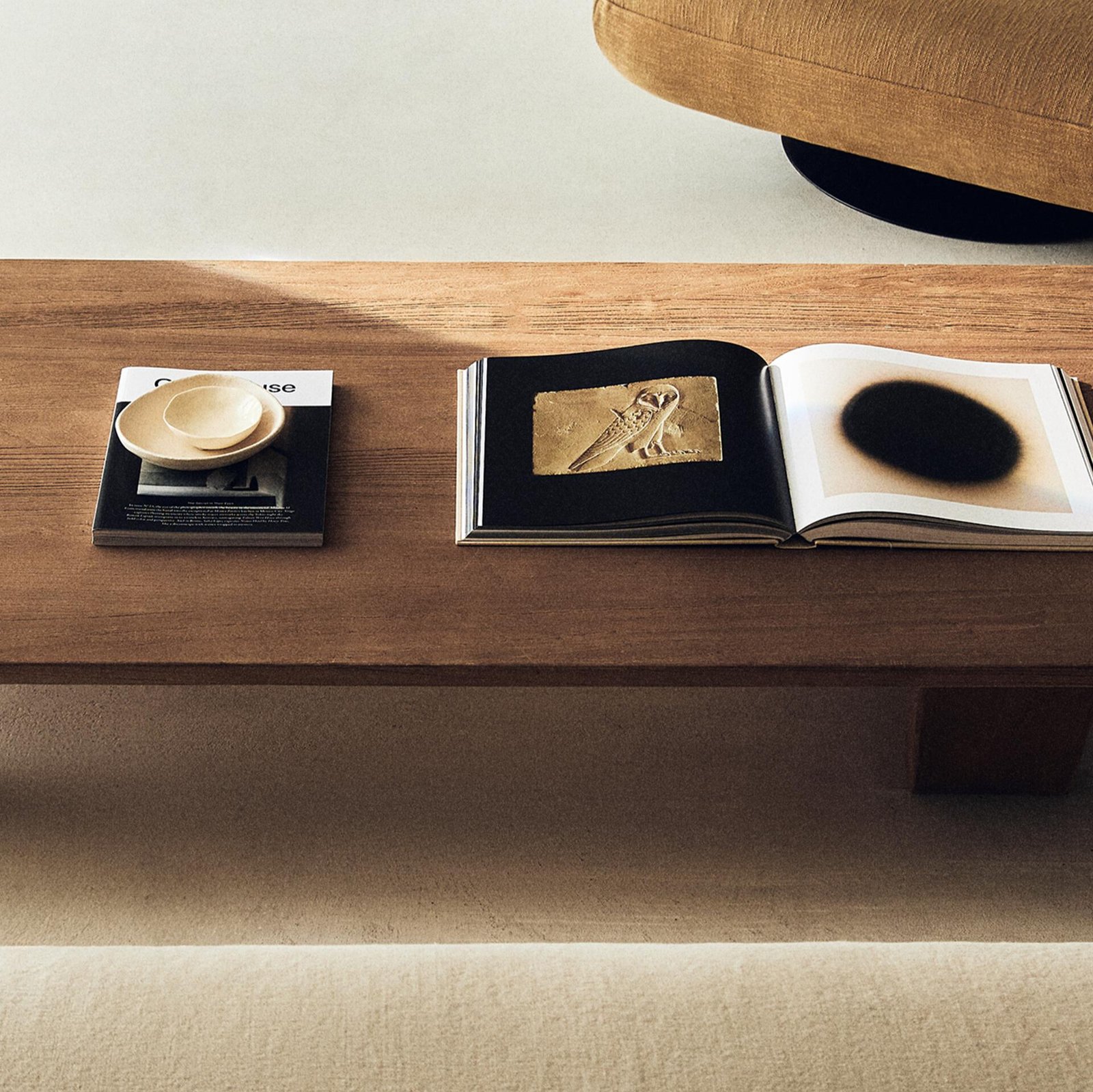 Elm wood coffee table with natural grain finish in a minimalist living room setting