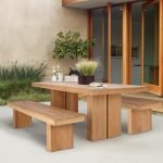 Solid teak Kayu dining table with natural wood grain in a modern dining room setting