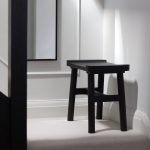 Kettil Milking Stool in black solid wood with three-legged rustic design