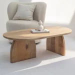 Brigitte Wooden Coffee Table with curved edges and natural finish in a serene modern living room