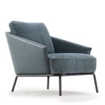 Clara Deluxe Armchair with soft upholstery, elegant silhouette, and modern tapered legs.