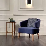 Forme Seat Arm Chair with sculpted fabric seat and slim armrests in a minimalist living room