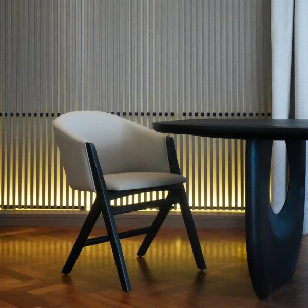 Crown Comfort Chair in velvet upholstery with tall back and flared arms in a modern living room