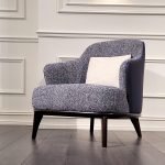 NestEase Arm Chair in soft linen fabric with curved back and plush cushions in a cozy living space