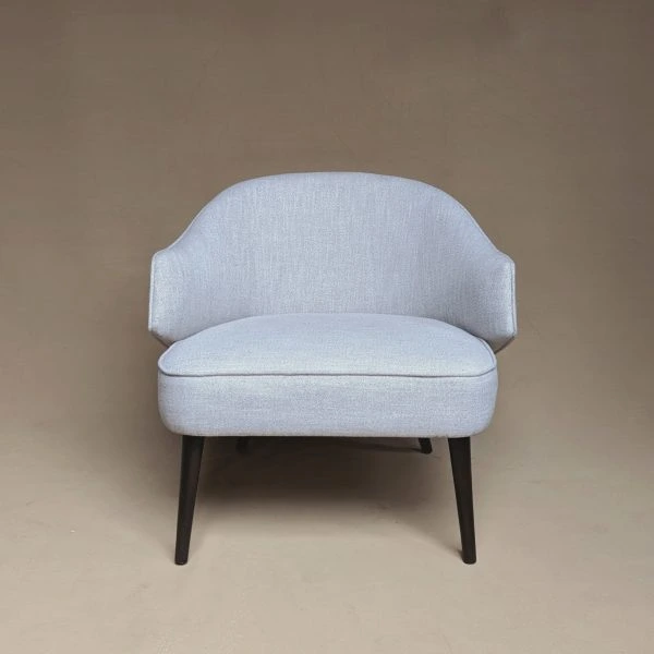 Milo Edge Chair with angular backrest and upholstered seat in a modern interior