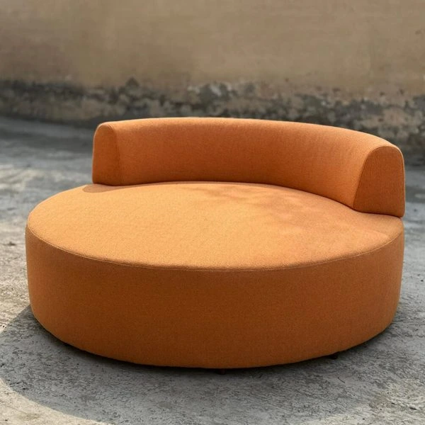 Nestle Lounger with soft upholstery and rounded curves in a warm living room