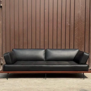 RegalRest Leather Lounger with rich brown leather and polished wood frame in a luxury living room