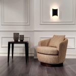 PlushHug Arm Chair in navy velvet with rounded arms and deep cushioning in a cozy living room setting