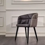 ModeSeat Chair with slim armrests and plush cushions in graphite grey fabric in a minimalist living room