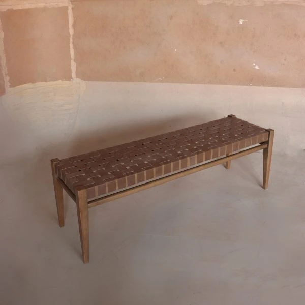Handwoven seat wooden bench with natural fiber weave and minimalist frame in a modern rustic interior