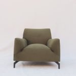 LoomBack Chair with cane-woven backrest and teak wood frame in a natural-toned room