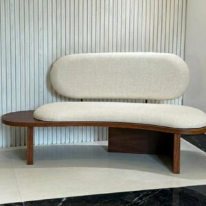 Modern curved wooden bench sofa with upholstered seat and backrest and built-in side table