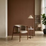 Modern solid wood dining armchair with beige leatherette upholstery and curved backrest