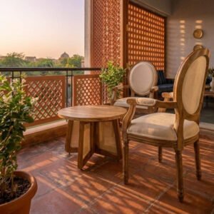 Handcrafted Teak wood armchair with an oval back and cream cushion upholstery on a sunlit balcony.