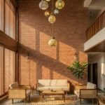 Wooden cane sofa set with beige cushions placed against a terracotta brick wall in a modern lounge setting