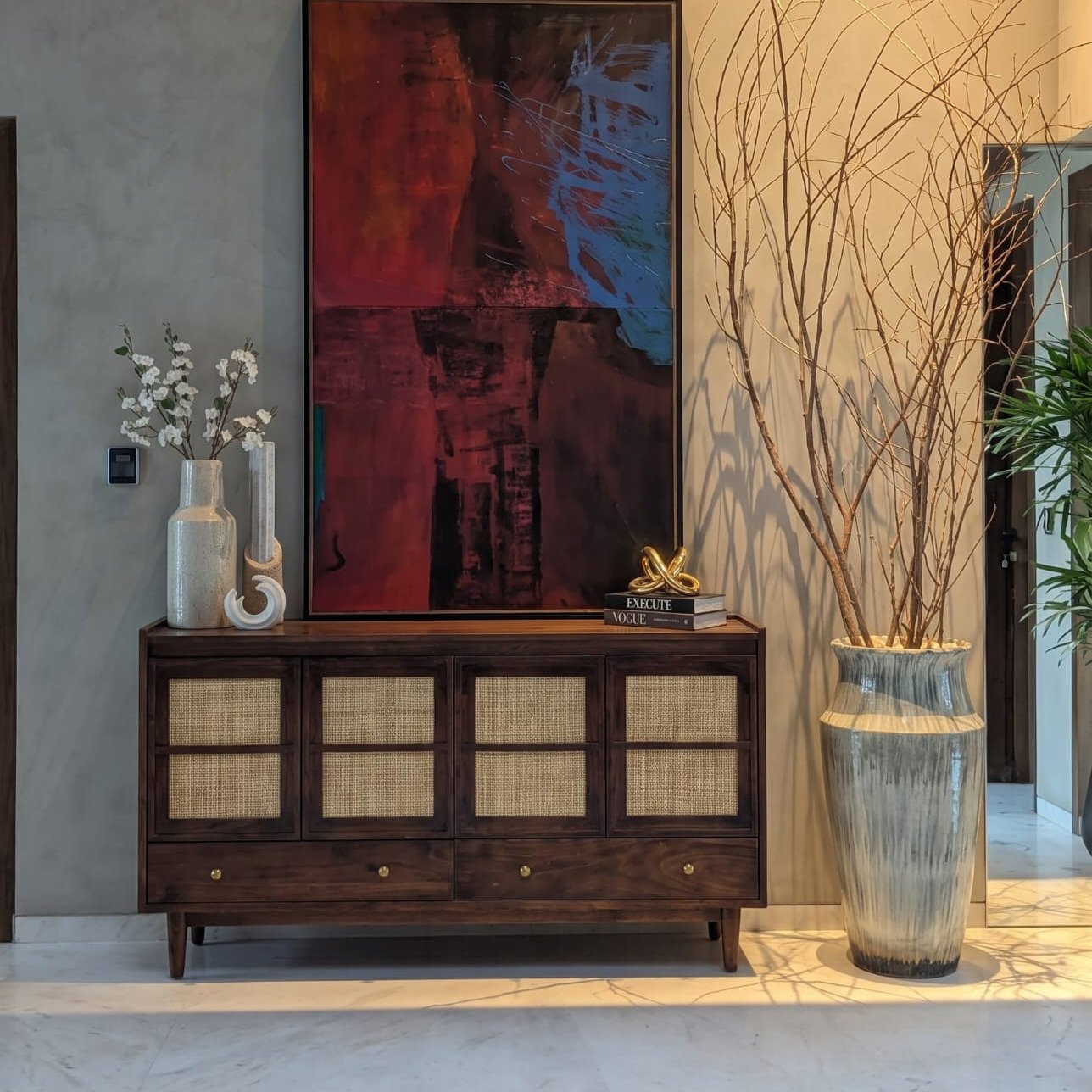 Varen Cane Sideboard with dark walnut-tone wooden frame, four natural cane-panelled cabinet doors, two storage drawers, and tapered wooden legs.