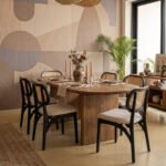 Siena six-seater dining set with natural wooden rectangular table, pedestal base, and six black cane-back chairs with beige upholstered seats.